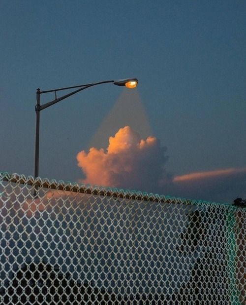 a street light on top of a chain link fence