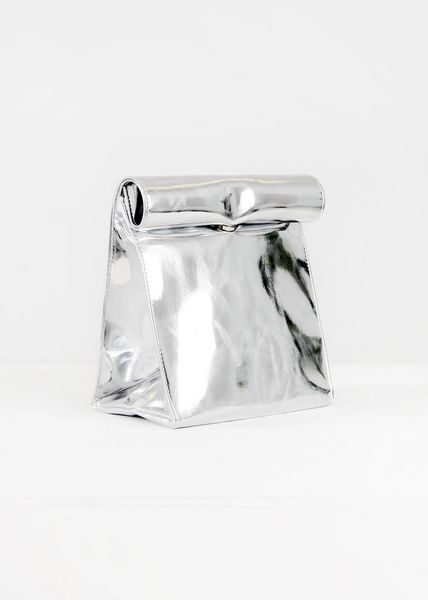 a silver purse sitting on top of a white table