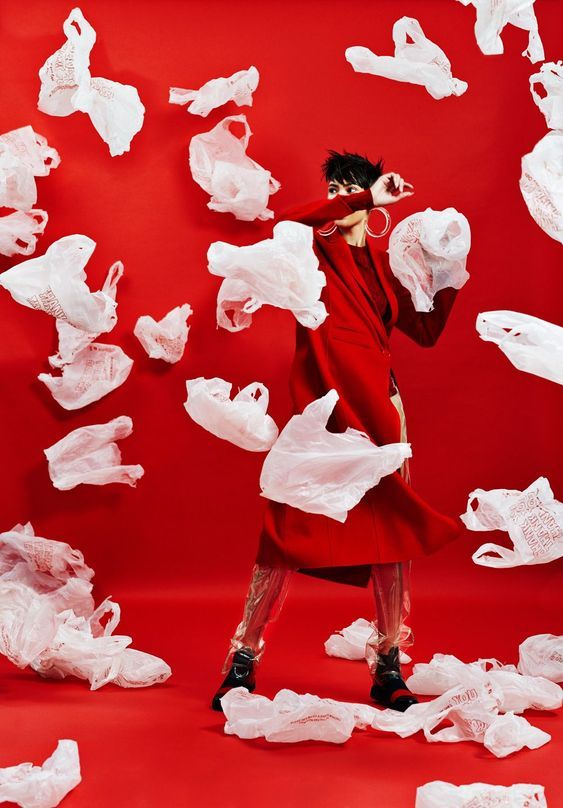 a woman in a red dress is surrounded by white tissue