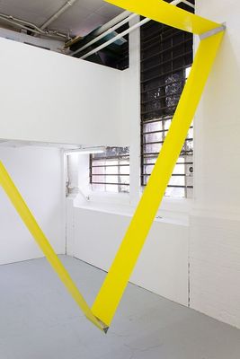 a white room with a yellow object hanging from the ceiling