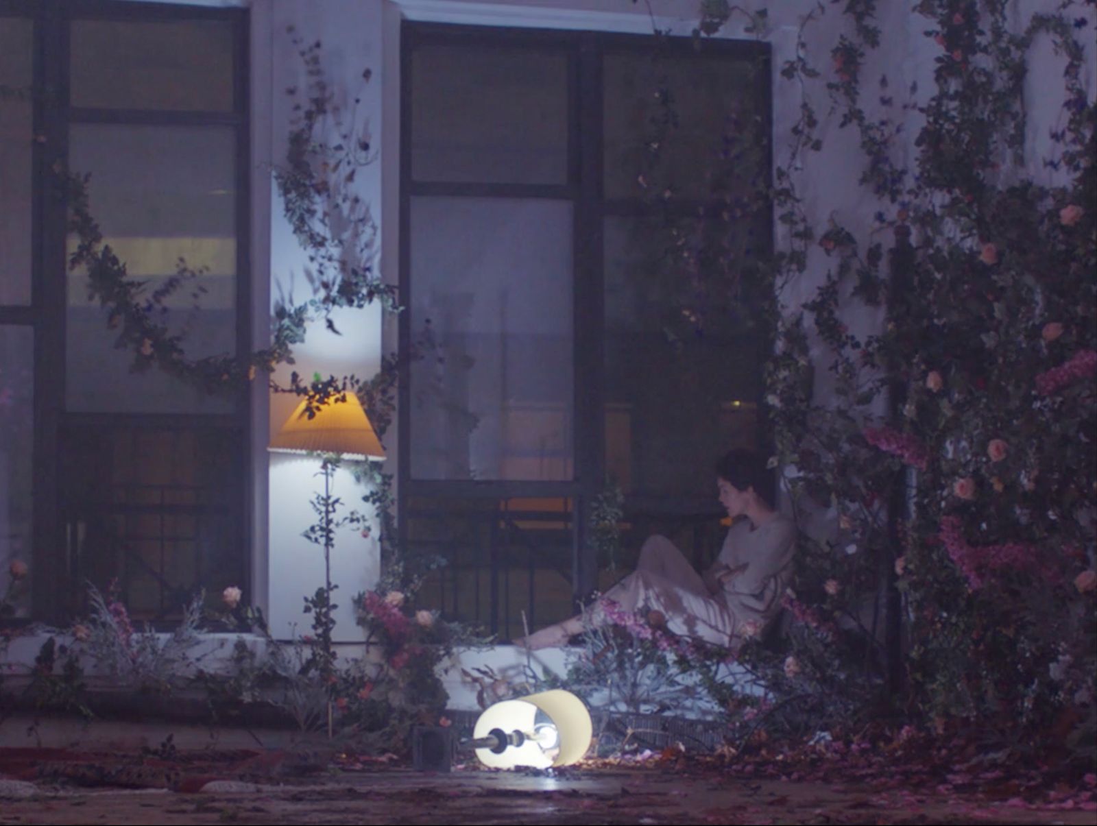 a person sitting on a porch next to a window