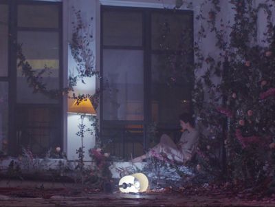 a person sitting on a porch next to a window