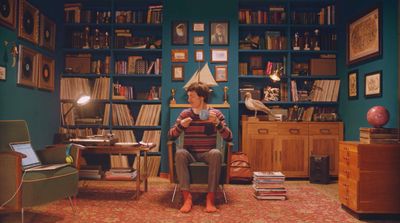 a woman sitting in a chair in front of a bookshelf