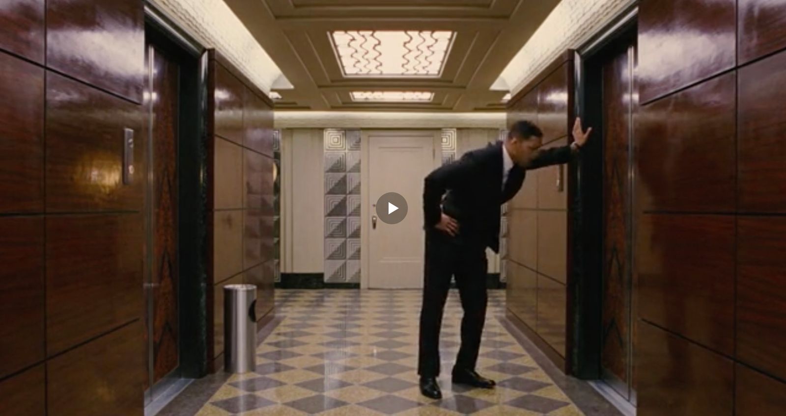 a man in a suit standing in a hallway