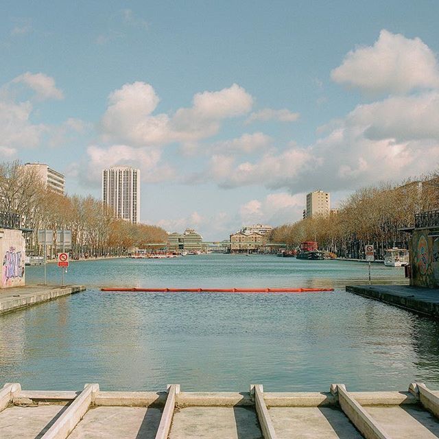 a body of water surrounded by tall buildings