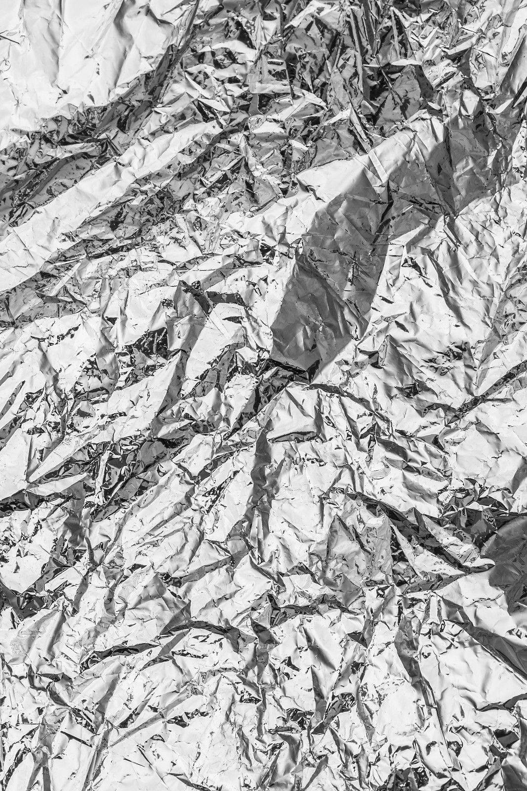 a black and white photo of a piece of tin foil