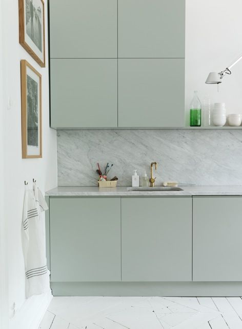 a kitchen with a marble counter top next to a sink