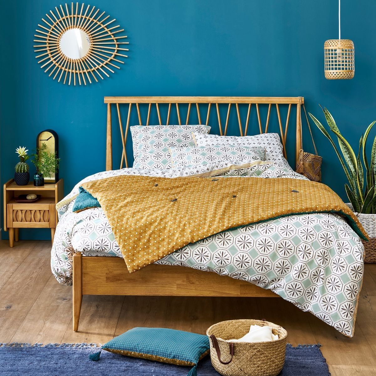 a bedroom with blue walls and a wooden bed