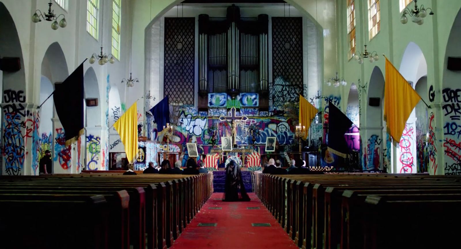 a church filled with lots of pews covered in graffiti