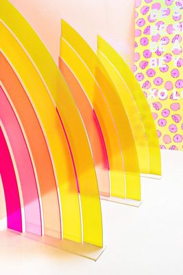 a row of rainbow colored paper sitting on top of a table