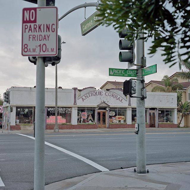 a no parking sign on the corner of a street