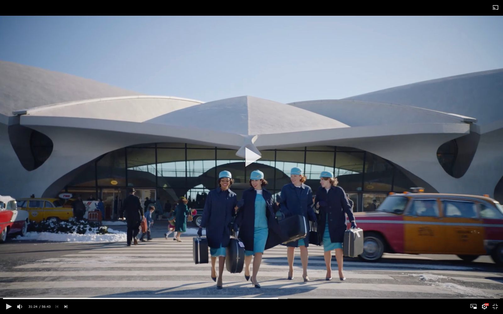 a group of women walking across a parking lot