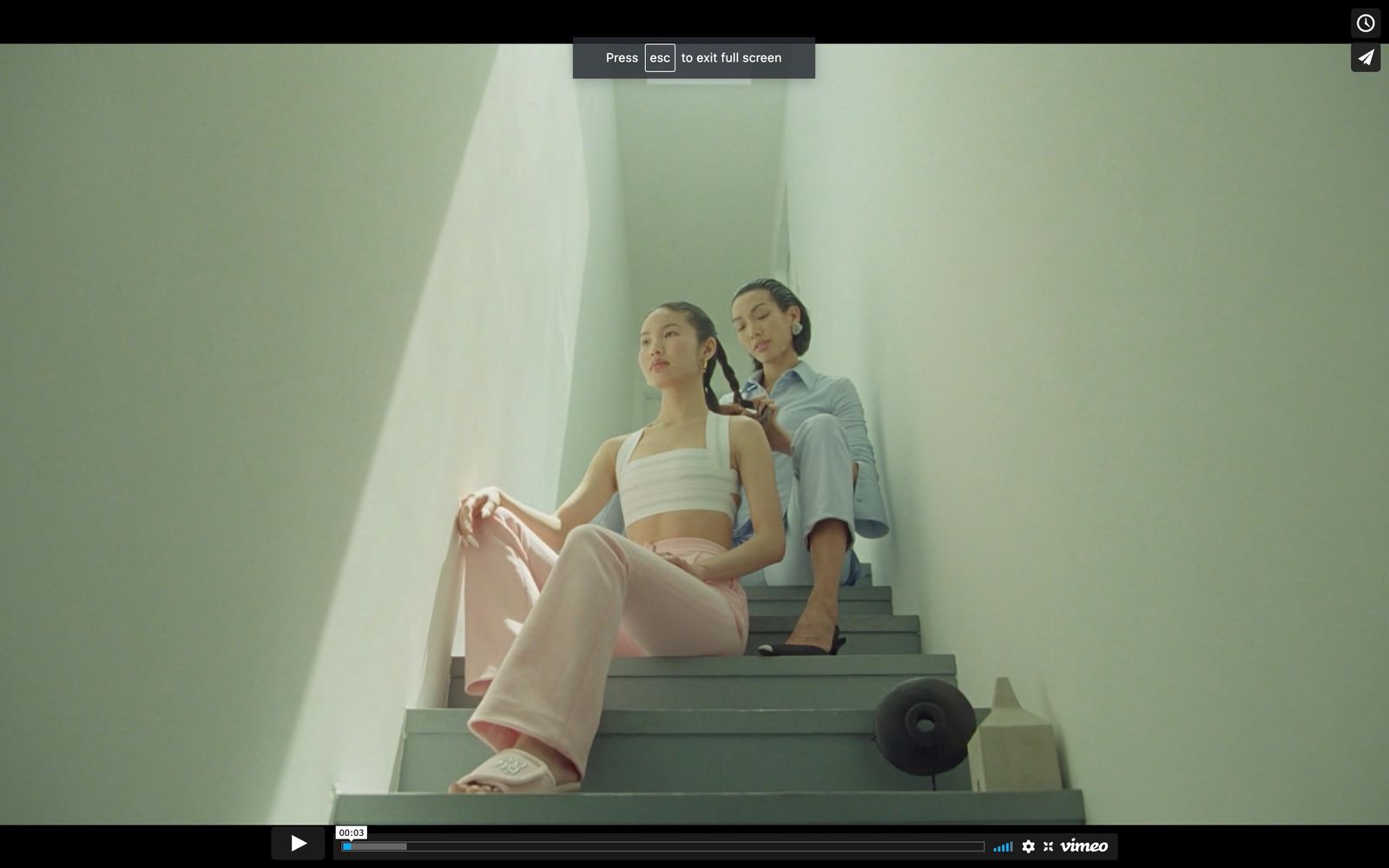 a couple of women sitting on top of a set of stairs