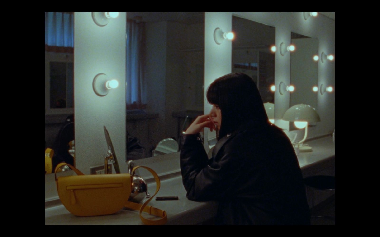 a woman in a hijab is looking at her reflection in a mirror