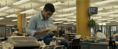 a man sitting at a desk in an office