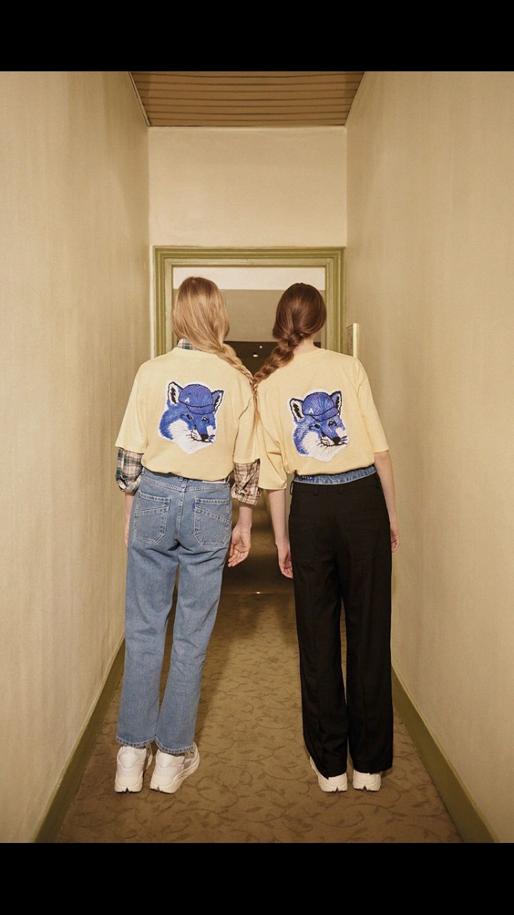 two women are walking down a hallway together