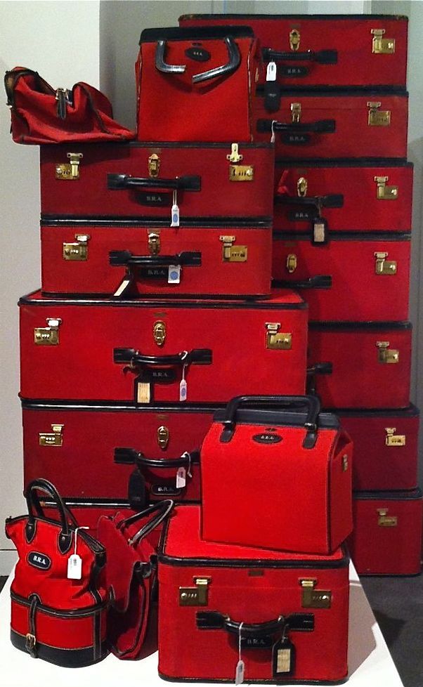 a pile of red suitcases sitting next to each other