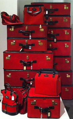 a pile of red suitcases sitting next to each other