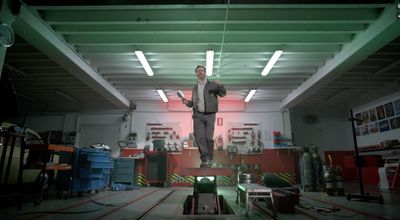 a man standing on a platform in a garage