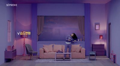 a woman standing on a couch in a living room