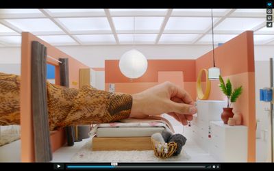 a person holding a cup in a room with orange walls