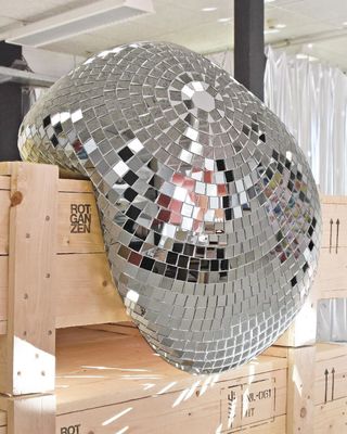 a large mirror ball sitting on top of a wooden crate