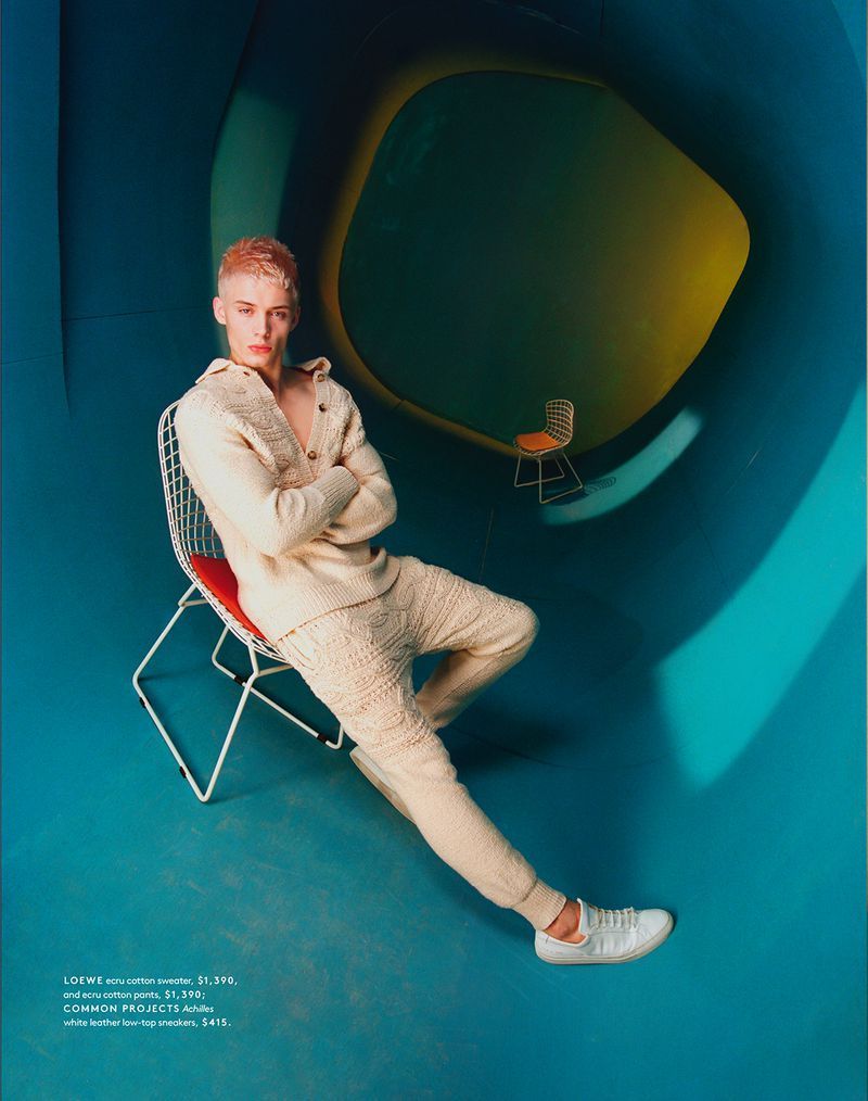 a man sitting on a chair in a room