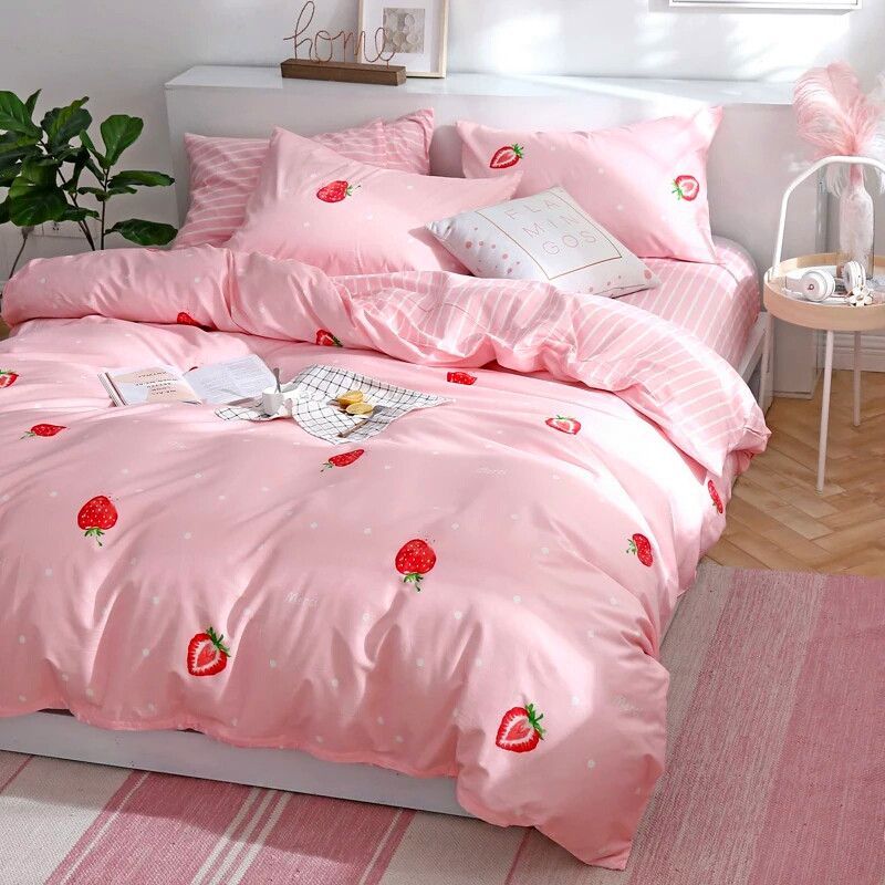 a bed with a pink comforter and pillows