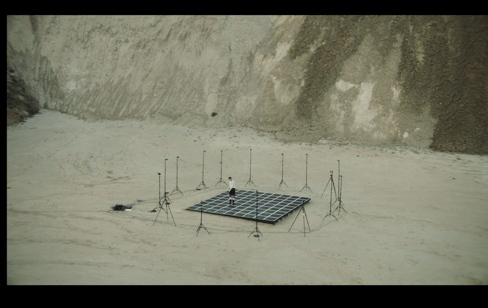 a group of cell phones sitting on top of a sandy ground