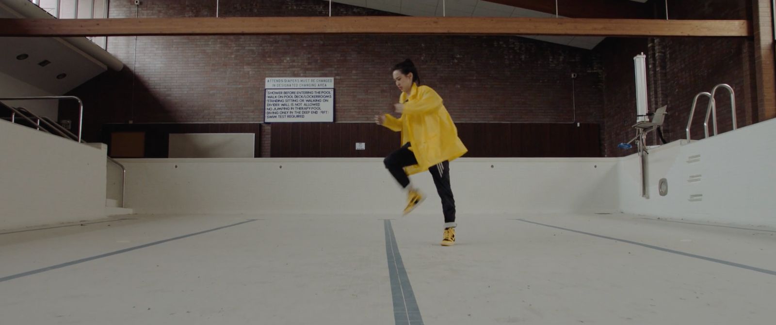 a woman in a yellow coat is running