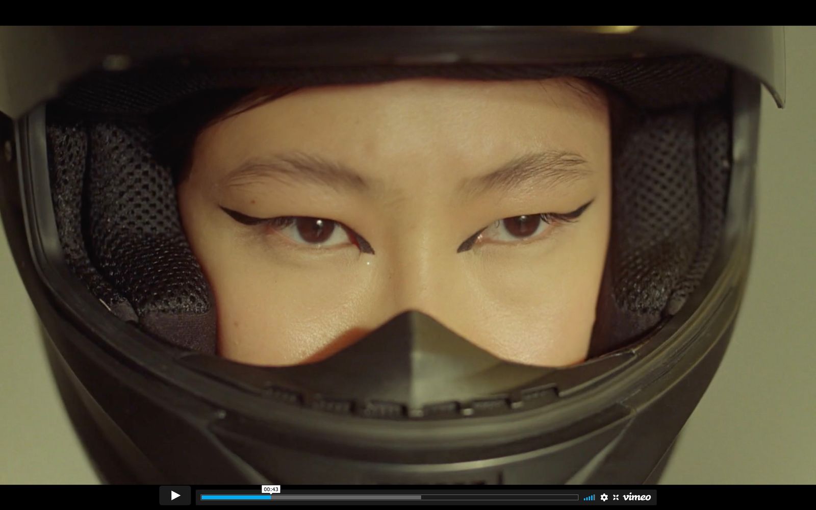 a woman wearing a helmet with her eyes closed