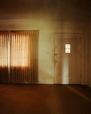 an empty room with a door and a window