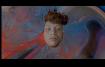 a young man with red hair and blue eyes