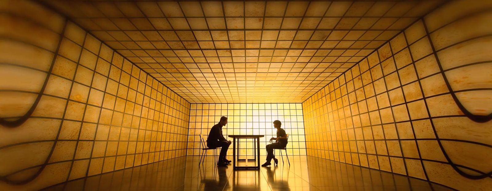 a couple of people sitting at a table in a room