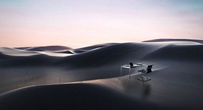 a desk and chair in the middle of a desert