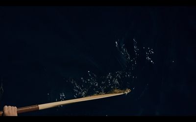 a person rowing a boat in the dark water