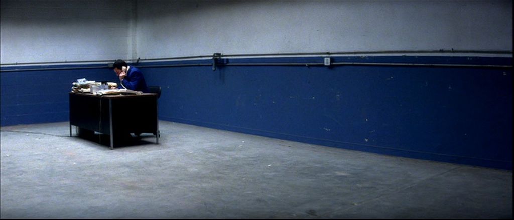 a man sitting at a desk in a room