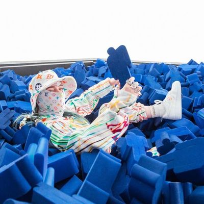 a doll laying on top of a pile of blue blocks