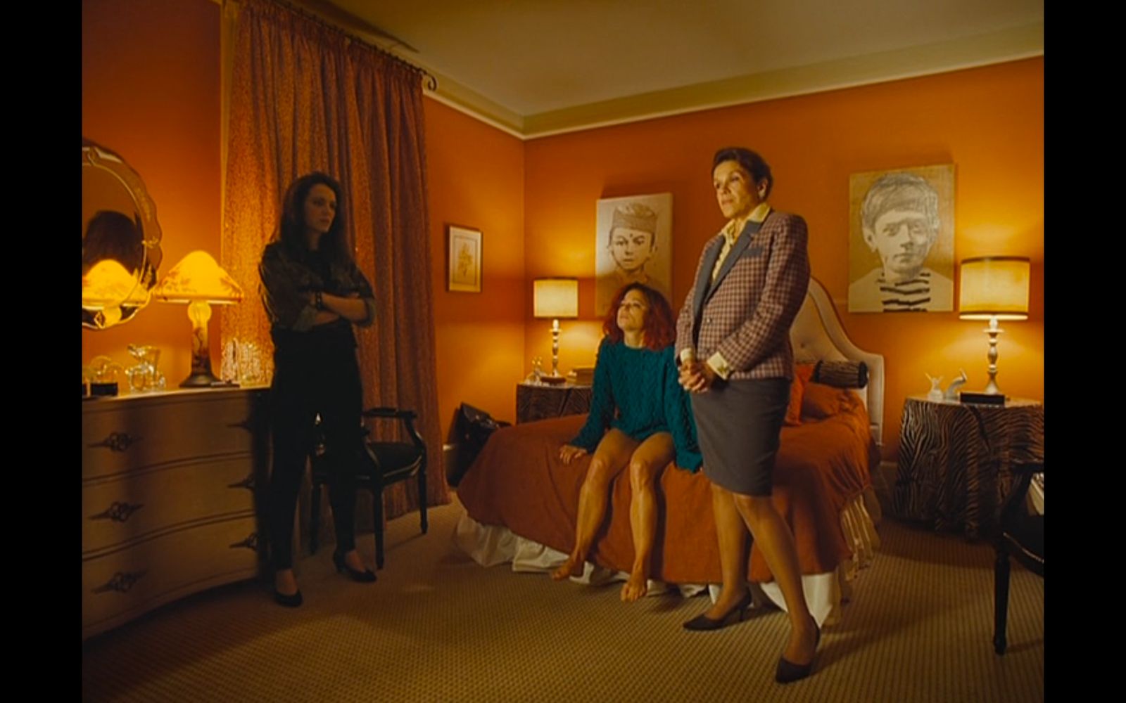 a group of women standing in a bedroom next to each other