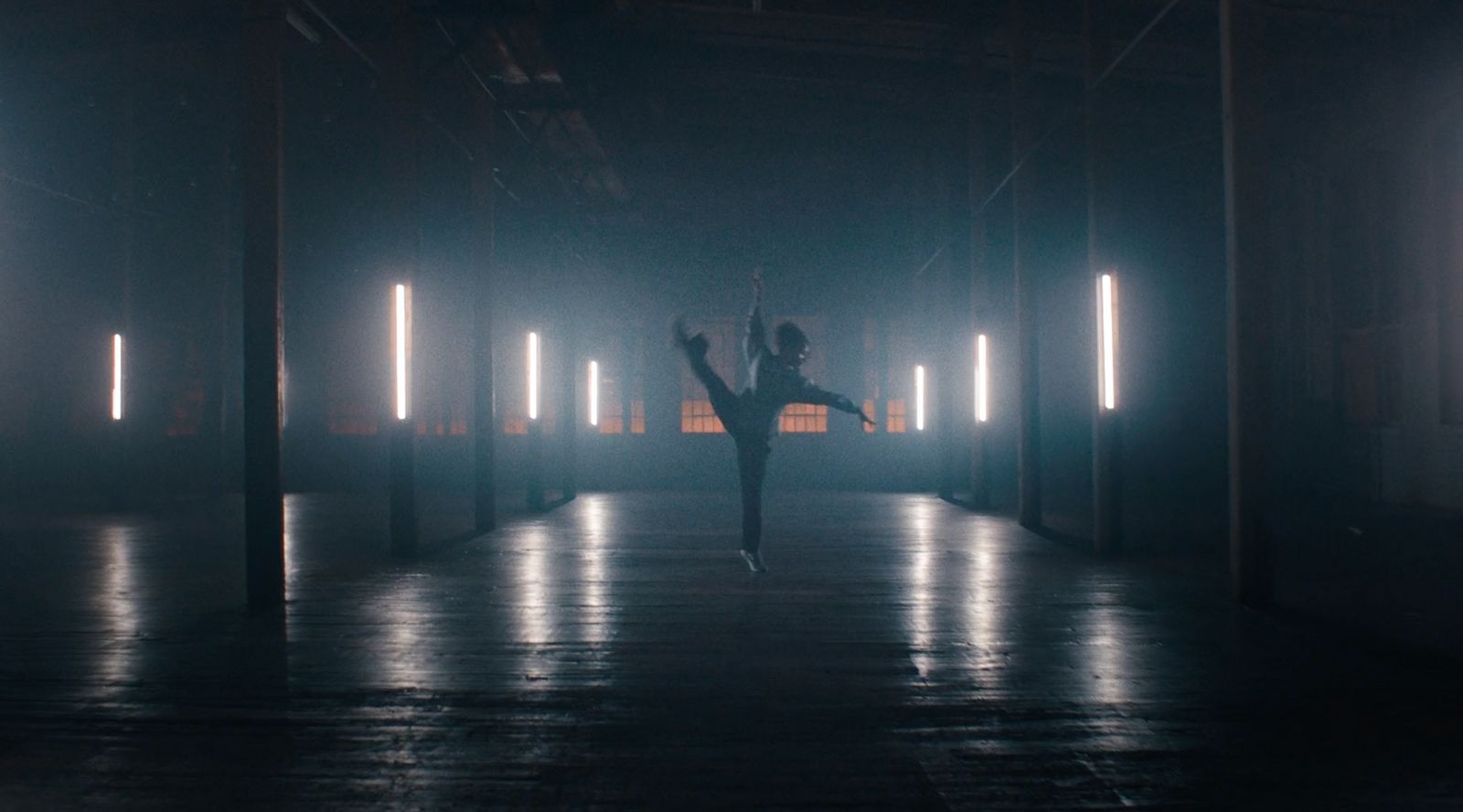 a person standing in the middle of a dark room