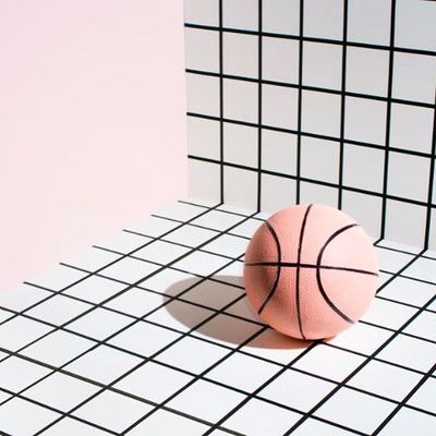 a pink ball sitting on top of a white tiled floor