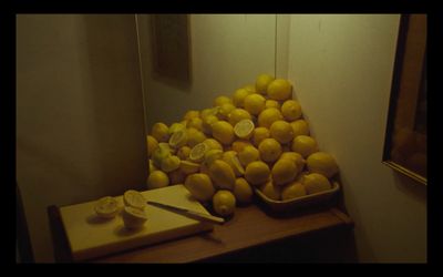 a pile of lemons sitting on top of a wooden table