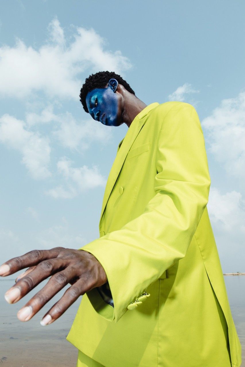 a man in a yellow suit and blue face paint