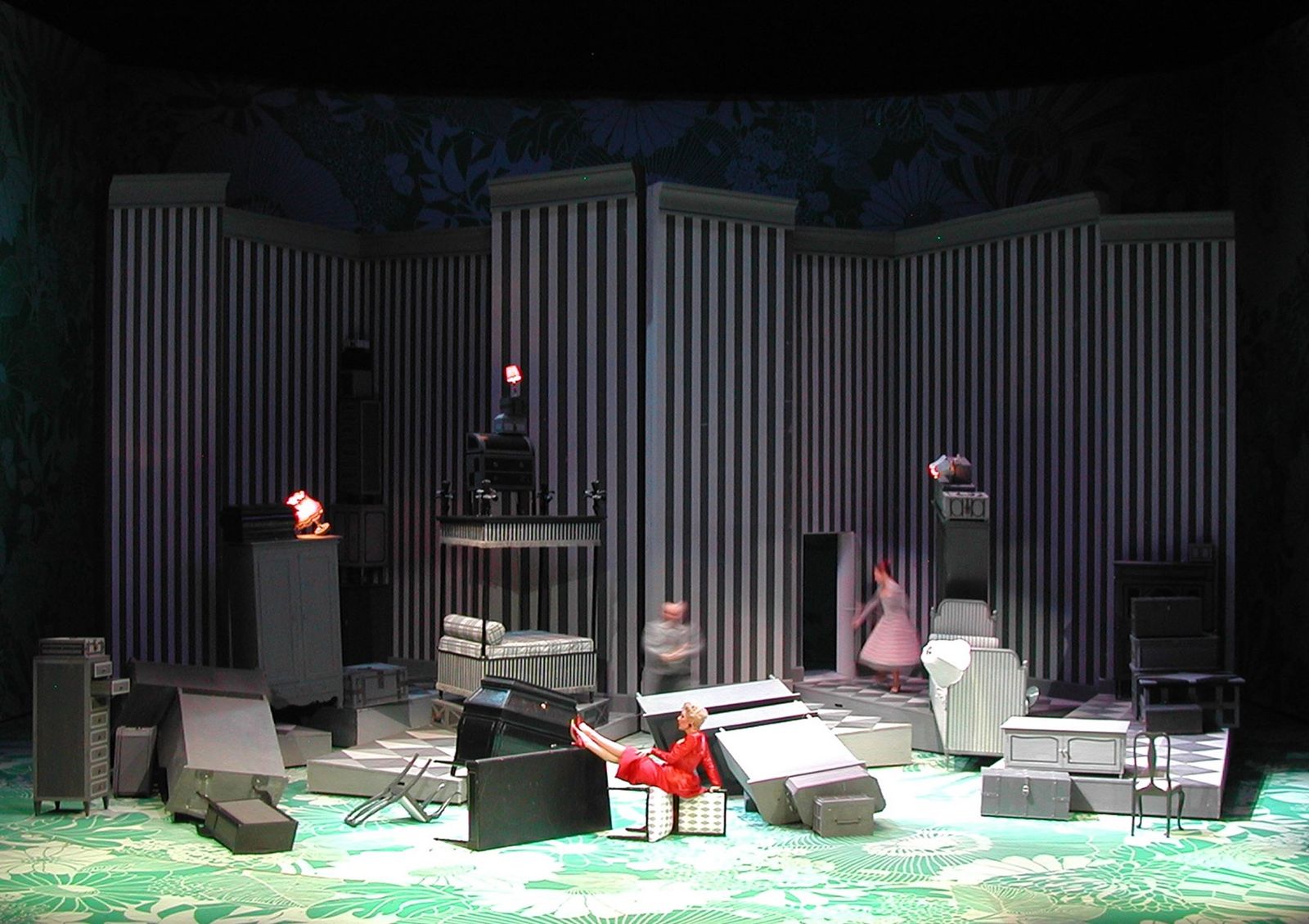 a stage set with a man sitting in a chair