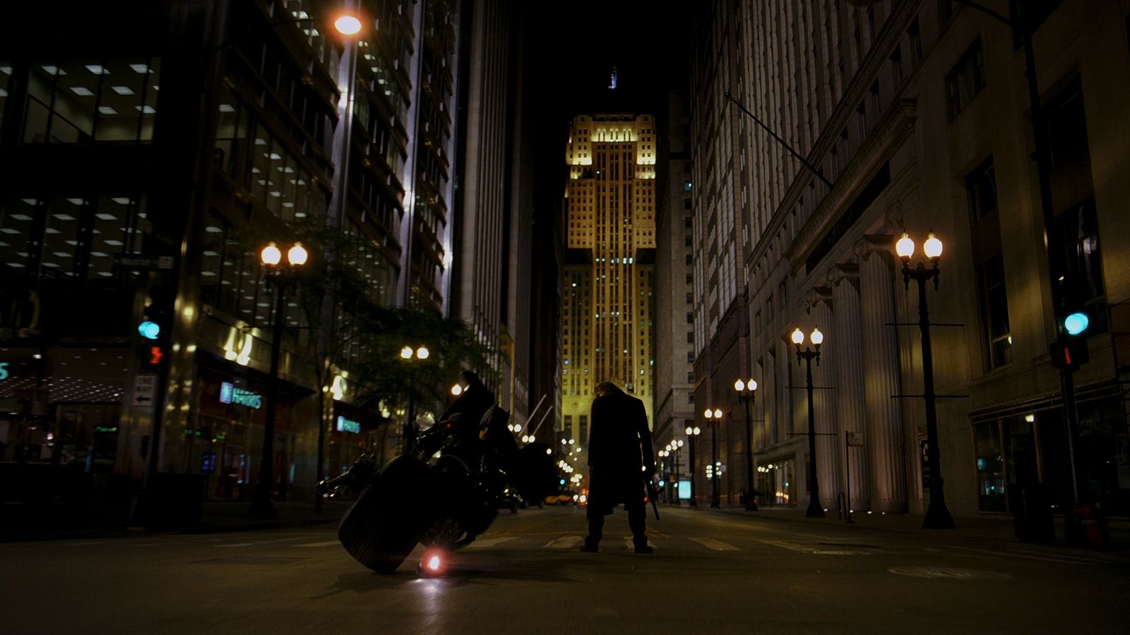 a man standing in the middle of a street at night