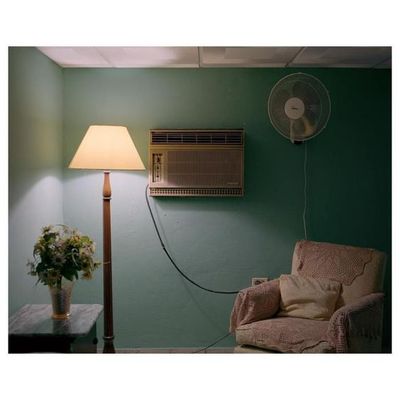 a living room with a fan and a lamp