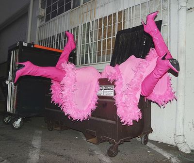 a couple of pink costumes laying on top of a luggage cart