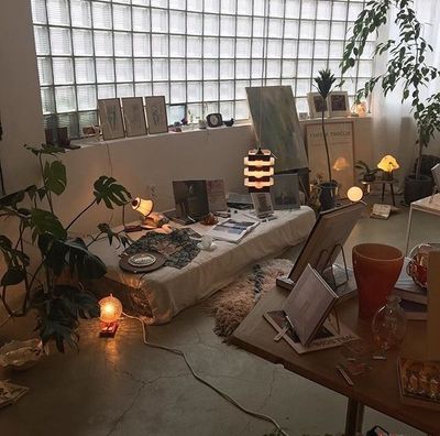 a living room filled with lots of furniture and plants