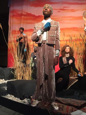 a man in a costume standing on a stage