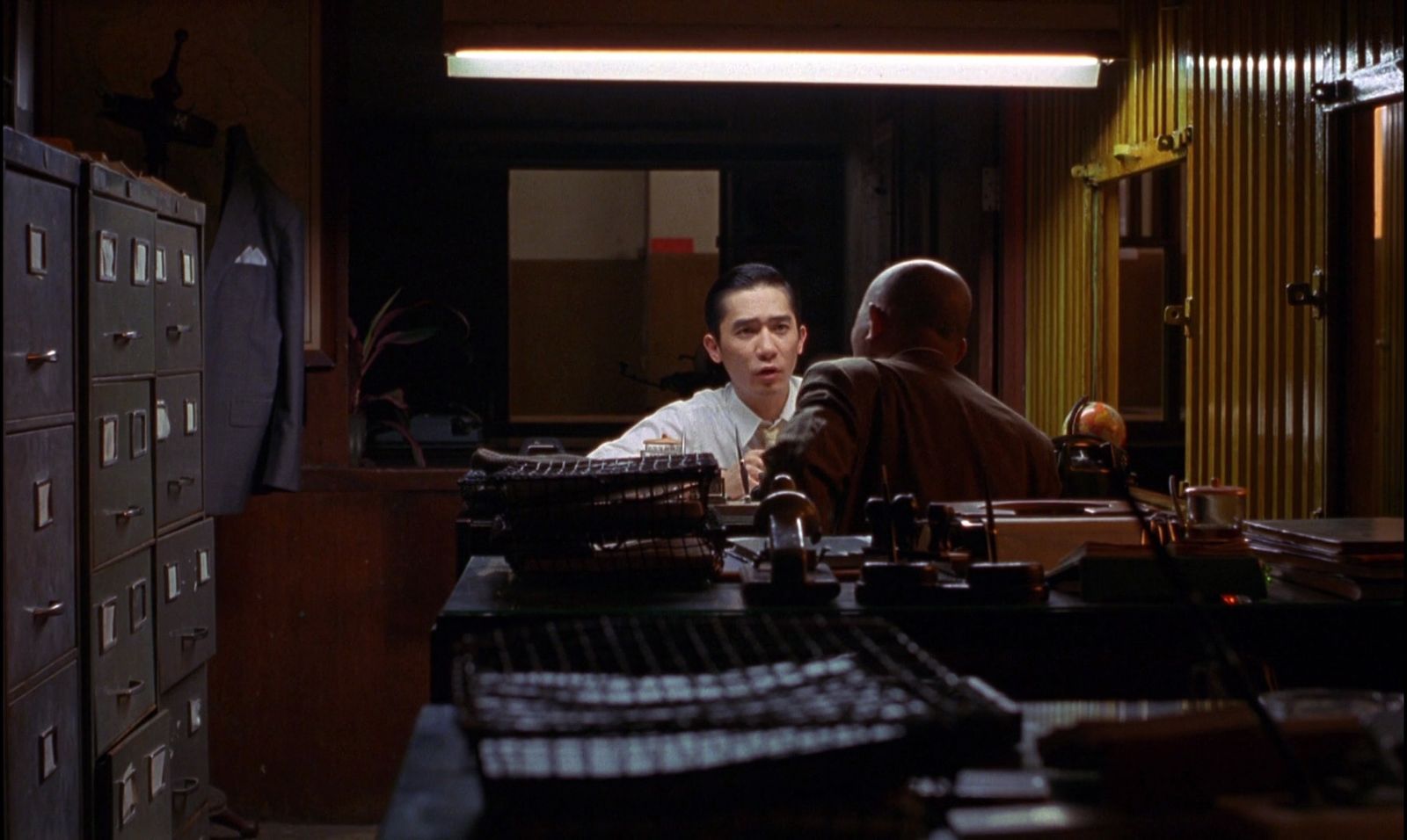 a man sitting at a desk in front of a computer